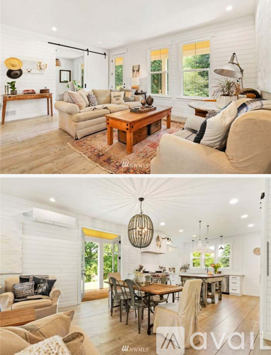 A living room with a couch, a coffee table, and a dining table.