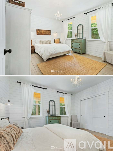 A bedroom with a white bed and a green dresser.
