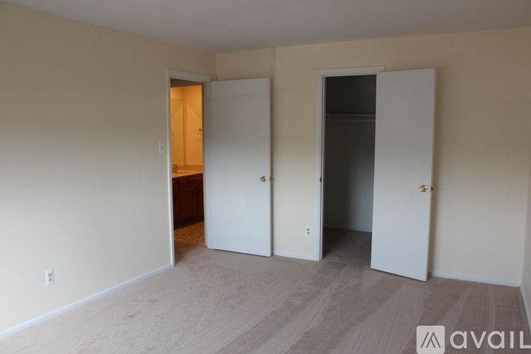 A room with two white doors and a wooden cabinet.