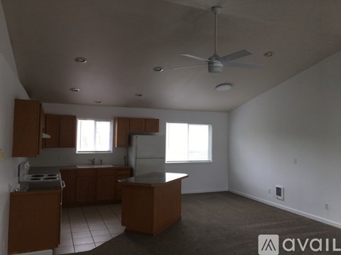 A kitchen with brown cabinets and a white ceiling.