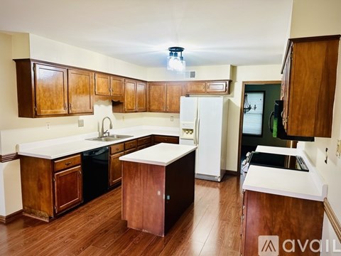 A kitchen with wooden cabinets and a white countertop.