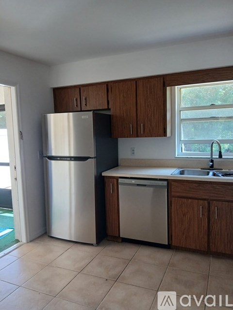 A kitchen with a stainless steel refrigerator and dishwasher.