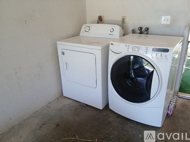 A white dryer and washer are sitting next to each other.