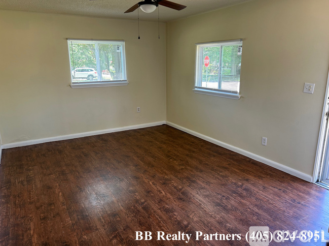 A room with a BB Realty Partners sign on the floor.