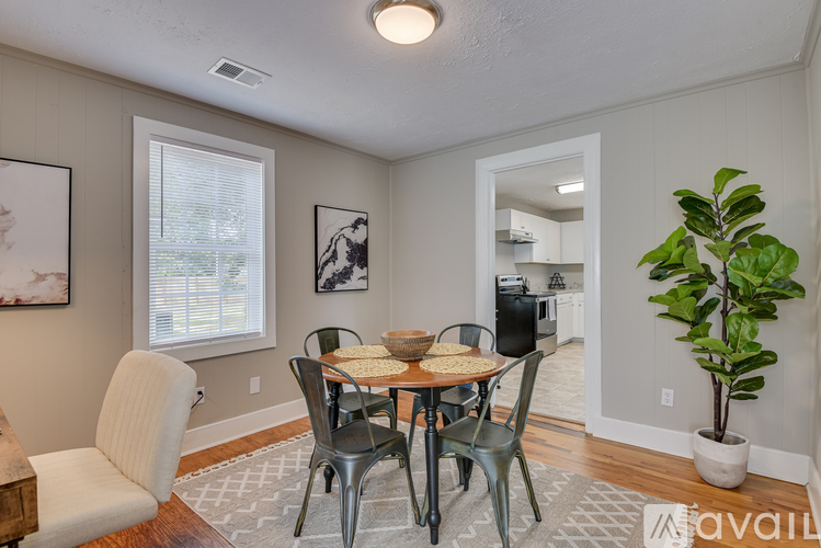 A dining room with a table and chairs.