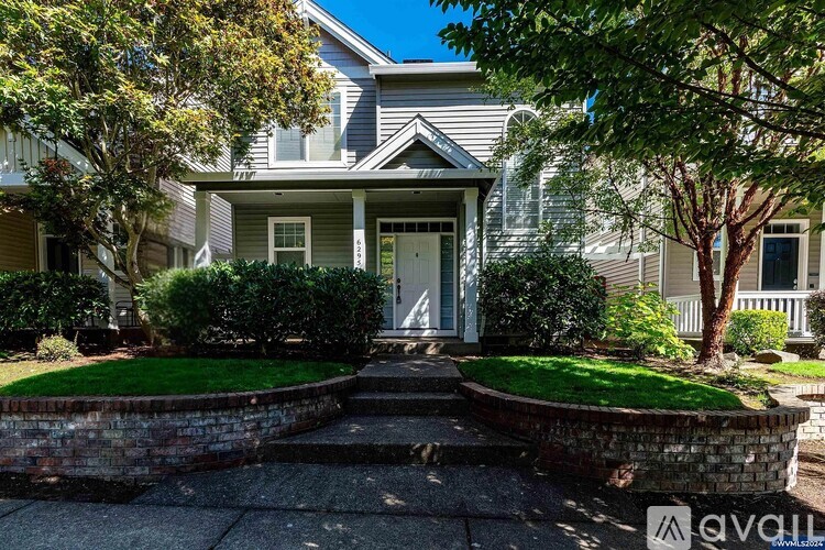 A house with a front yard and a driveway.