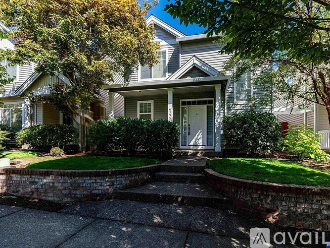 A house with a front yard and a driveway.