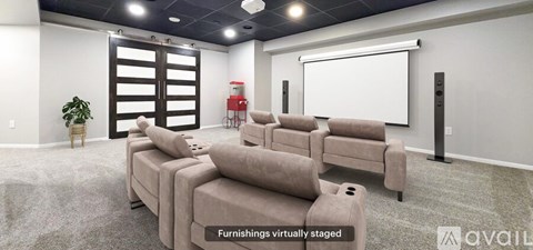A living room with a row of couches and a projector screen.