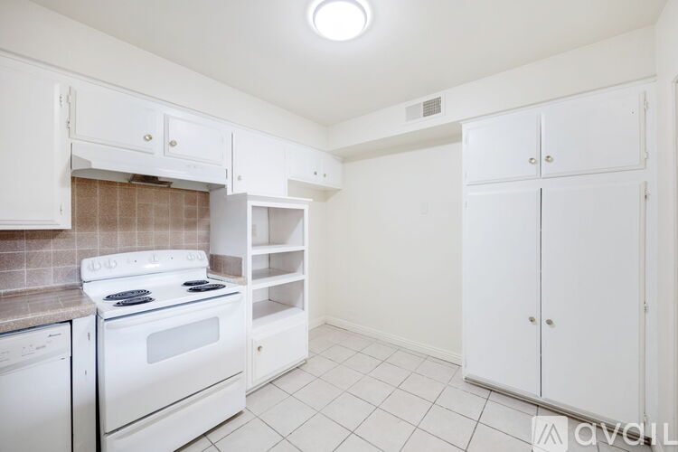 A kitchen with white appliances and cabinets.