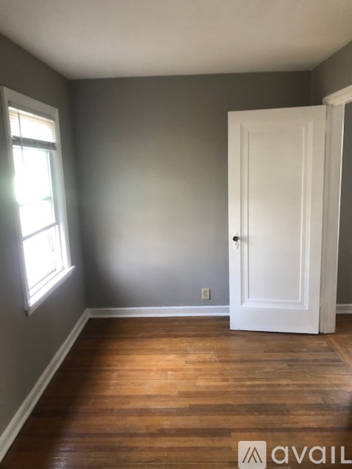 A room with a white door and a window.