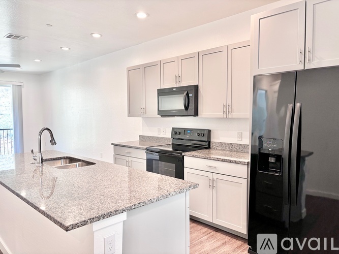 A kitchen with granite countertops and stainless steel appliances.