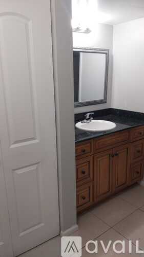 A bathroom with a sink and a mirror.