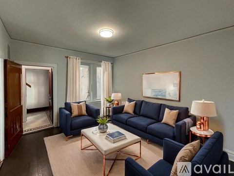 A living room with a blue sofa and a coffee table.