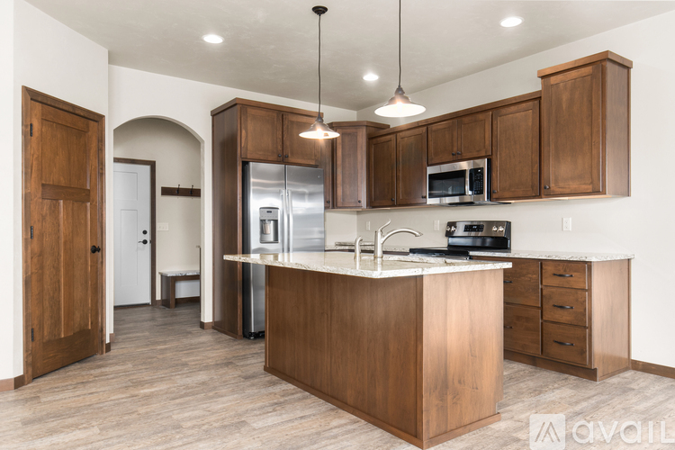 A kitchen with wooden cabinets and a center island.