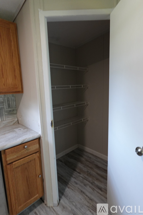 A kitchen with a white door and a counter top.