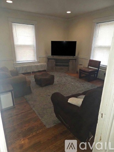 A living room with a television and a couch.