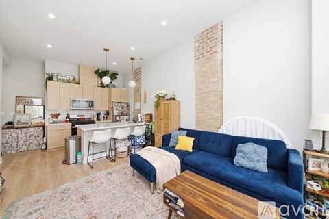 A living room with a blue couch and a wooden coffee table.