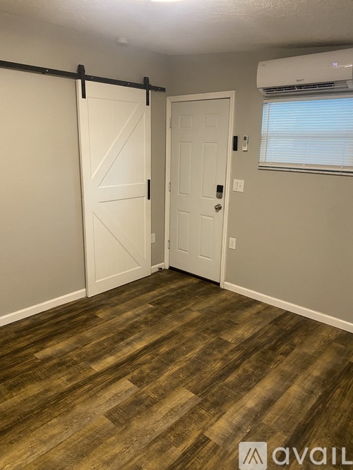A room with a sliding door and a white door.