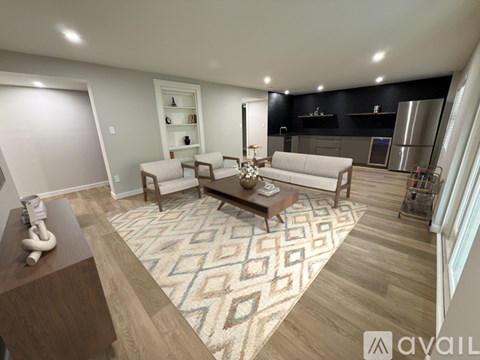A living room with a patterned rug and a wooden coffee table.