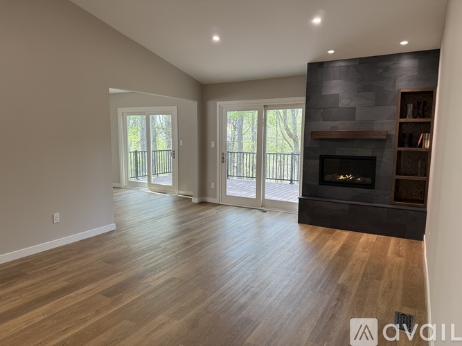 A spacious living room with a fireplace and sliding glass doors.
