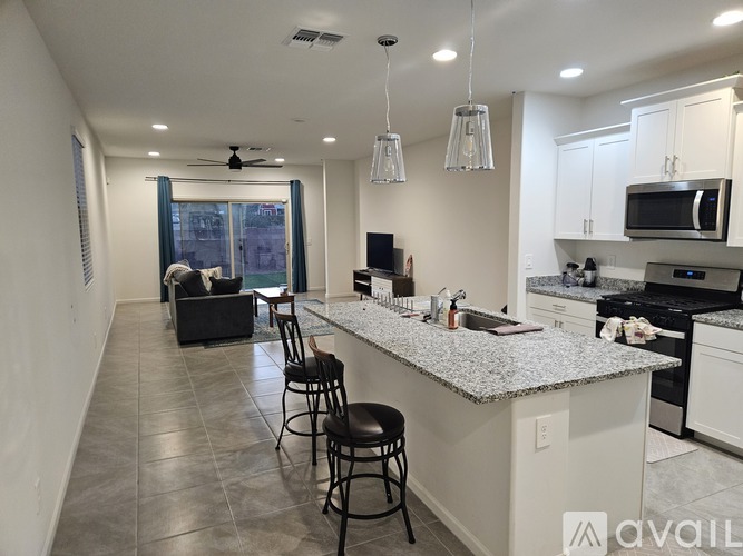 A kitchen with a bar area and a dining area with a table and chairs.