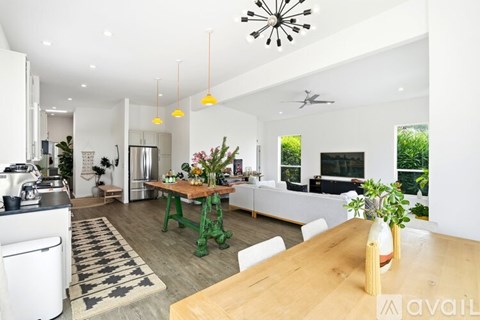 A modern kitchen with a dining table and chairs.