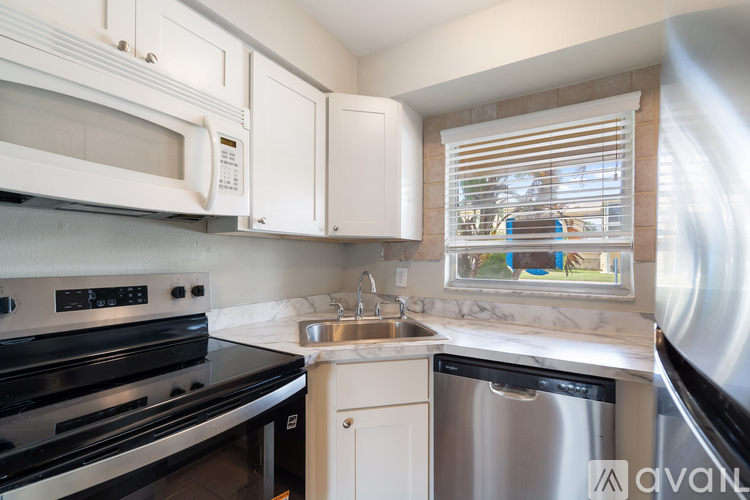 A kitchen with a stove, microwave, and dishwasher.