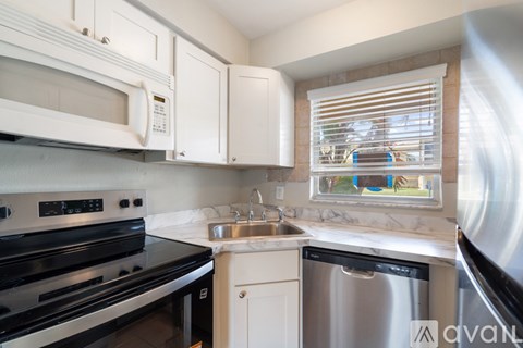 A kitchen with a stove, microwave, and dishwasher.