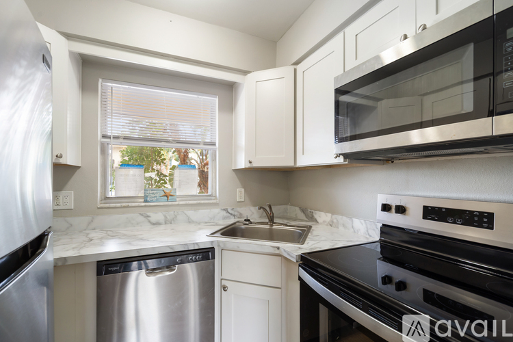 A kitchen with a stainless steel dishwasher and oven.