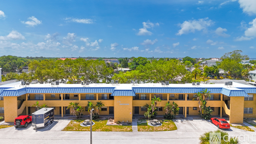 A large building with a parking lot in front of it.