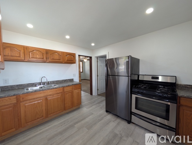 A kitchen with wooden cabinets and stainless steel appliances.