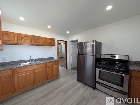 A kitchen with wooden cabinets and stainless steel appliances.