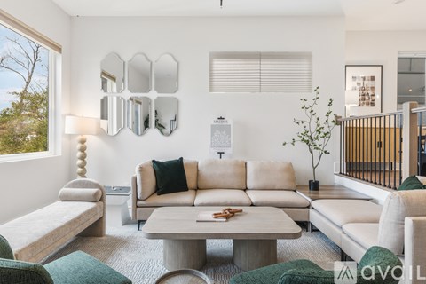 A living room with a white couch and a green chair.