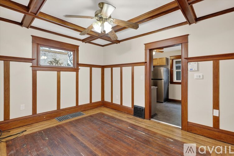 A room with wooden floors and a ceiling fan.