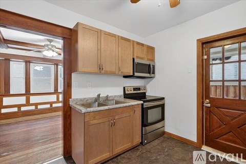 A kitchen with wooden cabinets and a stainless steel oven.