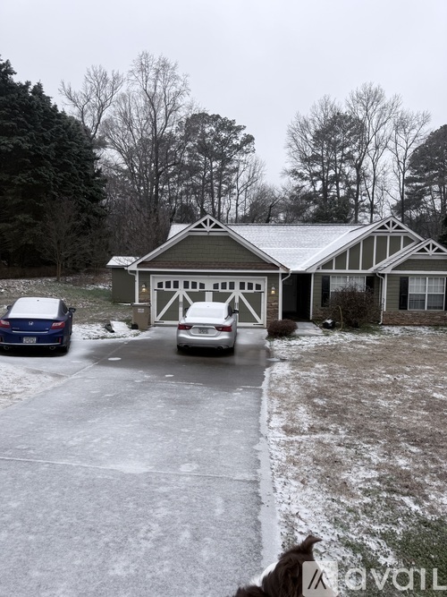 A house with a car parked in front of it.