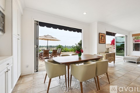 A dining room with a table set for four.