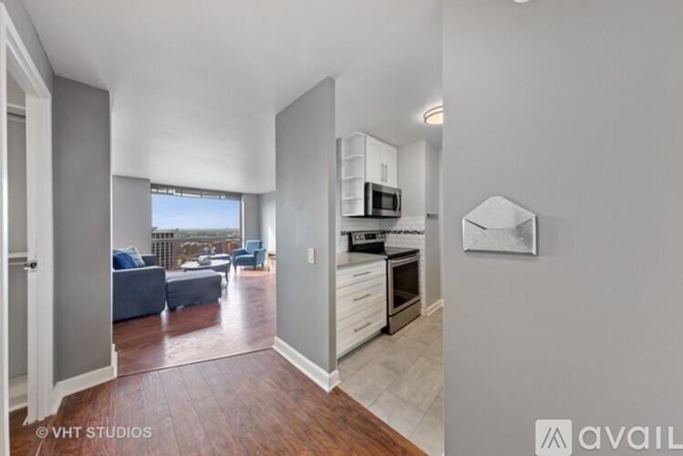 A modern kitchen with a microwave above the stove and a dining area with a table and chairs.