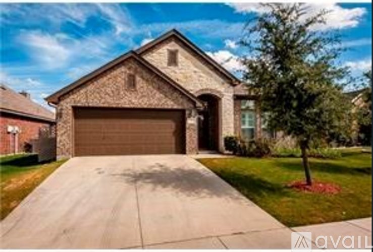 A house with a garage and a driveway is for sale.