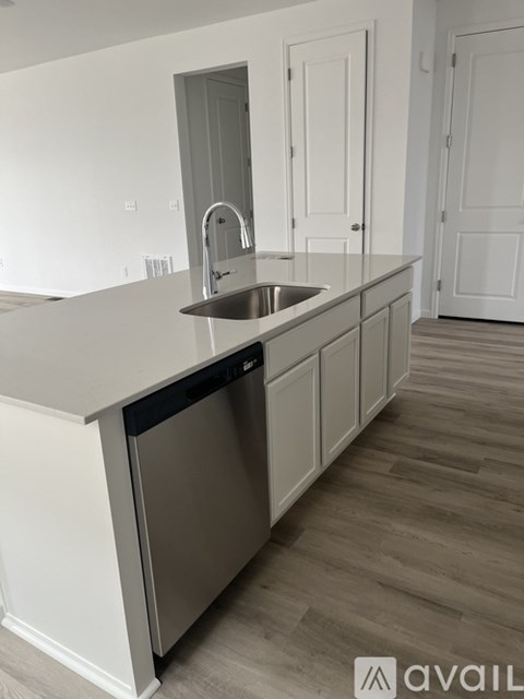 A kitchen with a sink and a dishwasher.