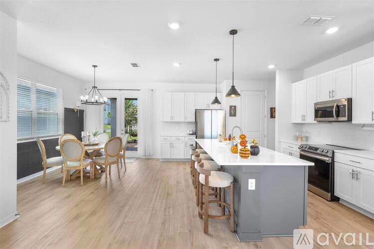 A modern kitchen with a dining table and chairs.