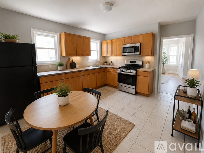 A kitchen with wooden cabinets and a black refrigerator.