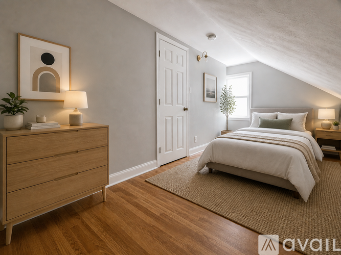 A bedroom with a bed, dresser, and window.