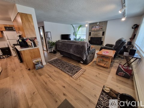 A living room with a grey couch and a wooden floor.