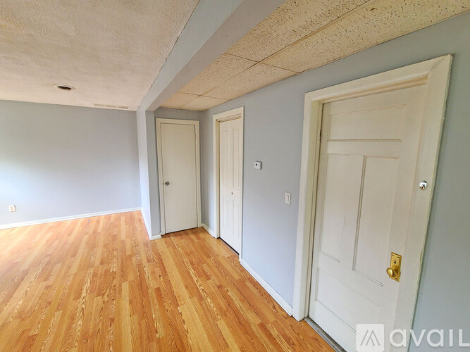 A room with wooden floors and white doors.