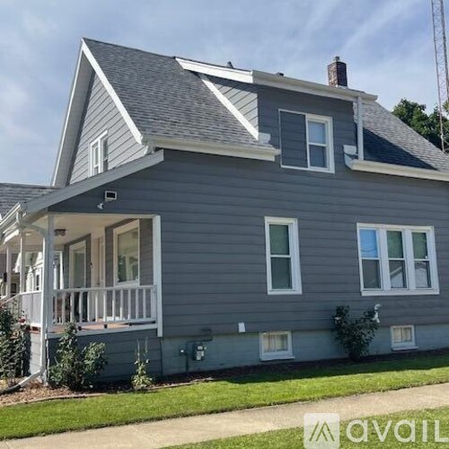 A house with a grey exterior and white trim.