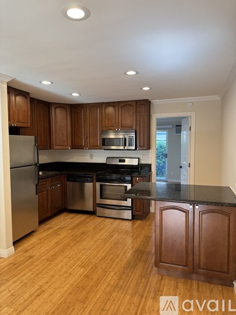A kitchen with wooden cabinets and stainless steel appliances.