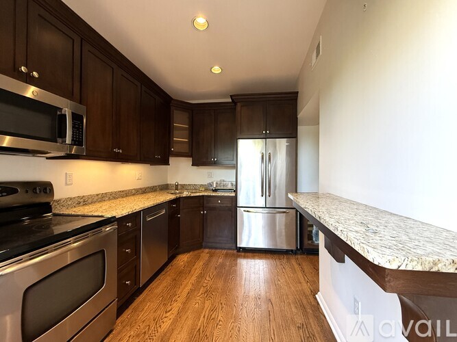 A kitchen with wooden cabinets and stainless steel appliances.