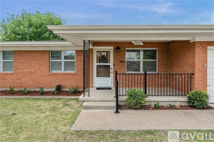 A brick house with the number 2166 on the front door.