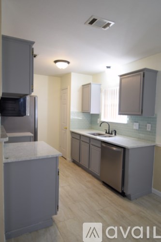 A kitchen with a sink and a microwave.